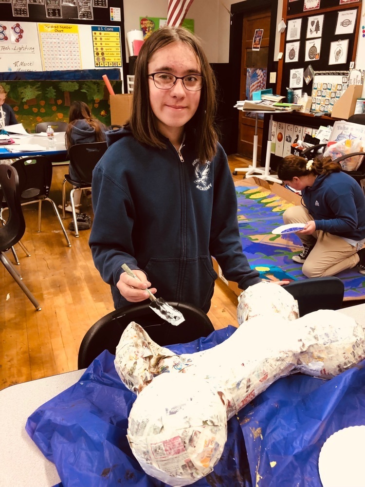 Painting paper mache’ dog bones.